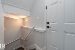 Paneled interior door with matte black hardware, featuring a built-in wall shelf - 