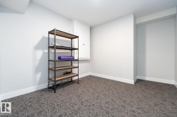 Recessed space featuring neutral-toned walls, patterned carpeting, and white baseboards - 