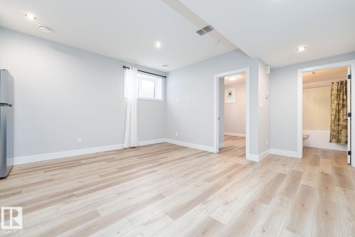 Staircase with patterned gray carpet, white risers, and a white handrail - Edmonton, AB 