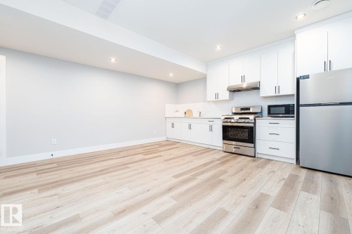 Room featuring light gray walls, patterned gray carpet, and white baseboards - Edmonton, AB 