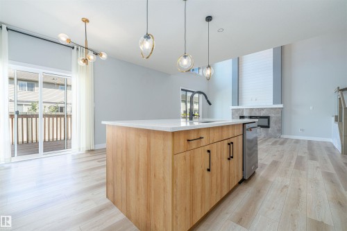 Open-concept interior featuring light wood-finish flooring - 17320 9 Avenue, Edmonton, AB 