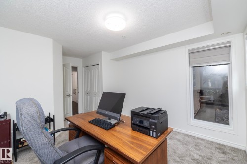 White walls and textured carpeting define this space, featuring a single window with a roller shade - 111 182 Haddow Close, Edmonton, AB 