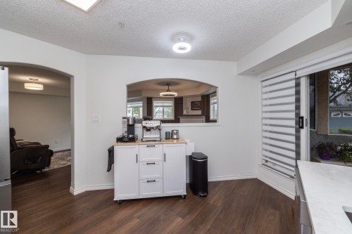 Dark wood-finish flooring with white baseboards throughout - 111 182 Haddow Close, Edmonton, AB 