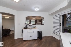 Dark wood-finish flooring with white baseboards throughout - 