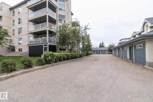 Multi-level residential building featuring private balconies with glass railings - 111 182 Haddow Close, Edmonton, AB 