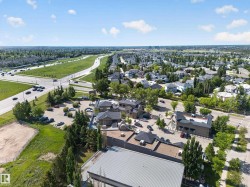 Aerial perspective showcasing commercial properties surrounded by established residential areas and green spaces - 