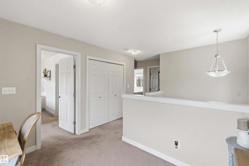 Upper-level landing featuring neutral carpeting and paint tones - 20013 131 Avenue, Edmonton, AB 