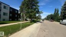 Multi-story residential building with light-colored siding and dark facade sections - 203 11445 41 Avenue, Edmonton, AB 