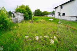 Expansive grassy yard area with fencing - 