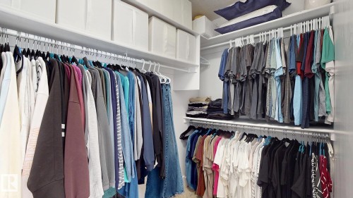 Custom closet system featuring multiple hanging rods and integrated shelving - 312 West Haven Drive, Leduc, AB 