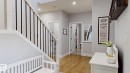 Entryway with wood-finish flooring, light gray walls, and white trim - 312 West Haven Drive, Leduc, AB 