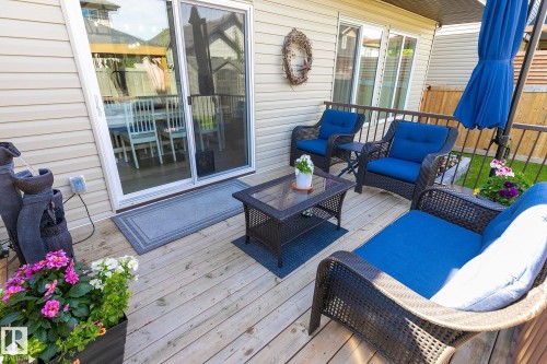 Wood-finish deck with a sliding glass door entry to the interior - 312 West Haven Drive, Leduc, AB 