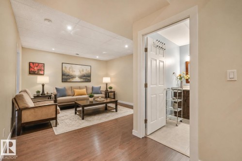 Basement living area virtually staged. - 32 Harrington Bay, Spruce Grove, AB 