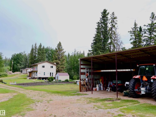 Open-sided metal pole barn providing covered storage - 58403 Rr 60, Rural Barrhead County, AB - Outdoor