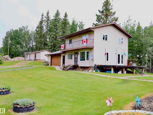 Two-story residence with light-colored siding and brown trim - 58403 Rr 60, Rural Barrhead County, AB - Outdoor
