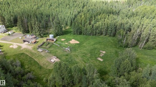 Expansive rural property featuring multiple outbuildings, an agricultural silo, and large fenced areas - 58403 Rr 60, Rural Barrhead County, AB - Outdoor With View