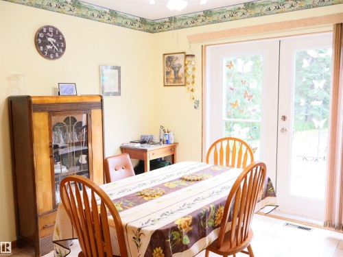 Dining area featuring light-colored walls and tile flooring - 58403 Rr 60, Rural Barrhead County, AB - Indoor Photo Showing Dining Room