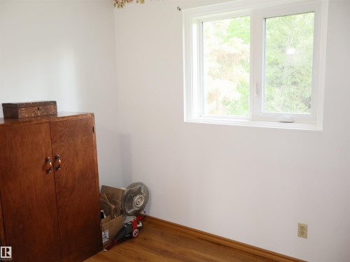 White walls with wood-finish flooring - 58403 Rr 60, Rural Barrhead County, AB - Indoor Photo Showing Other Room
