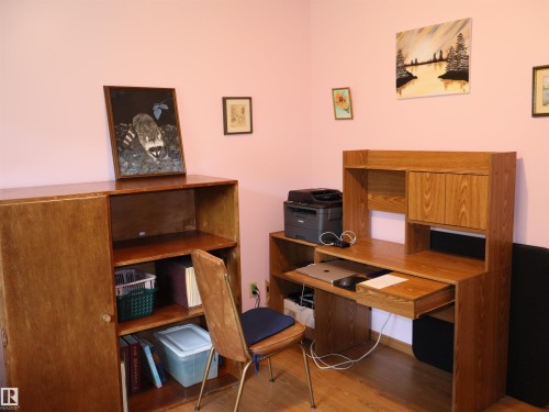 Wood-finish shelving unit and coordinating desk with built-in storage - 58403 Rr 60, Rural Barrhead County, AB - Indoor Photo Showing Other Room
