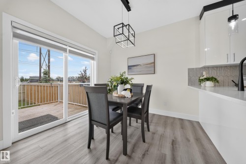 Sliding glass patio door opening onto a wooden deck - 1099 Eaton Road, Edmonton, AB 