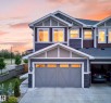 Modern multi-level exterior with varied siding textures and accent stone - 1099 Eaton Road, Edmonton, AB 