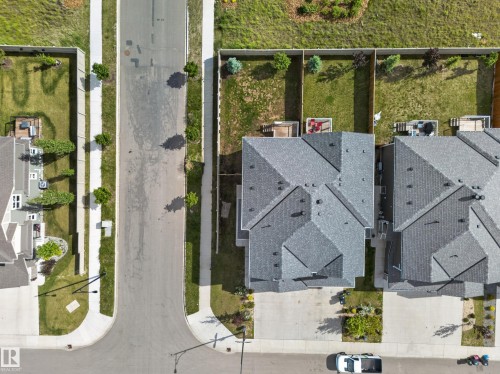 Overhead perspective showcasing a residential property with a multi-gabled gray shingle roof - 1099 Eaton Road, Edmonton, AB 