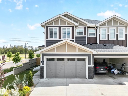 Modern multi-level exterior with varied siding, an attached garage, and a car-port - 1099 Eaton Road, Edmonton, AB 