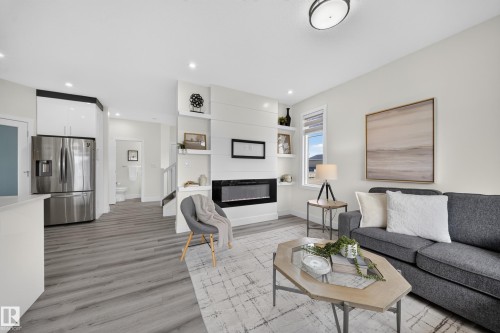 Bright open-concept living area with wood-finish flooring - 1099 Eaton Road, Edmonton, AB 