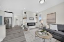 Bright open-concept living area with wood-finish flooring - 1099 Eaton Road, Edmonton, AB 