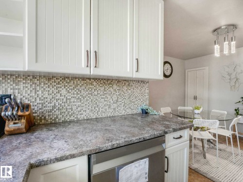 White shaker-style upper cabinetry with brushed nickel hardware - 9207 169 Street, Edmonton, AB - Indoor Photo Showing Kitchen
