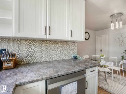 White shaker-style upper cabinetry with brushed nickel hardware - 
