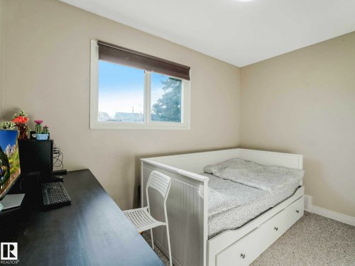 Neutral-toned walls and plush gray carpeting create a versatile interior - 9207 169 Street, Edmonton, AB - Indoor Photo Showing Bedroom