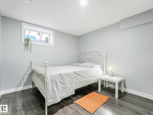 Light grey walls complement wood-finish flooring - 9207 169 Street, Edmonton, AB - Indoor Photo Showing Bedroom