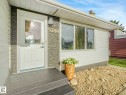 Crisp white siding exterior with a textured stone accent wall - 9207 169 Street, Edmonton, AB  - Outdoor With Exterior 