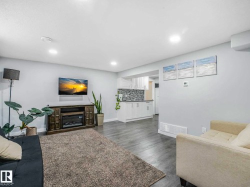 Open-concept living space featuring recessed lighting, light gray walls, and wood-finish flooring - 9207 169 Street, Edmonton, AB - Indoor Photo Showing Basement