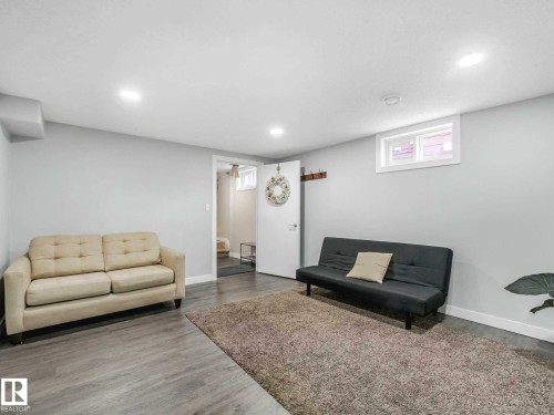 Versatile interior space featuring wood-finish flooring, recessed lighting, and a white egress window - 9207 169 Street, Edmonton, AB - Indoor Photo Showing Basement