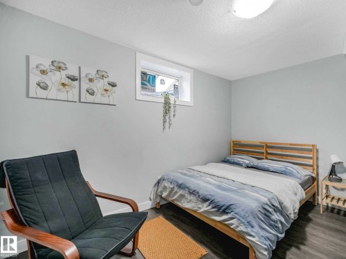 Room featuring light gray walls, wood-finish flooring, a single window, and a flush-mount ceiling light - 9207 169 Street, Edmonton, AB - Indoor Photo Showing Bedroom