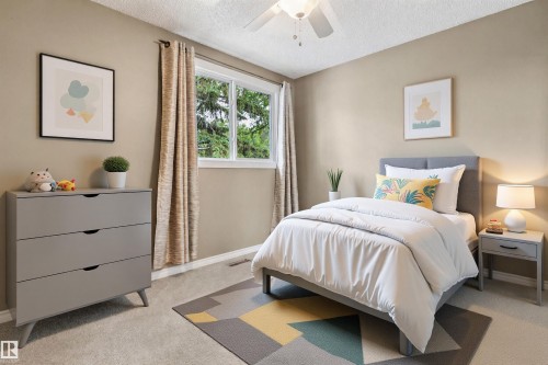 Bedroom featuring neutral wall tones, a ceiling fan with integrated lighting, and carpeted flooring - 1131 Hooke Road, Edmonton, AB 