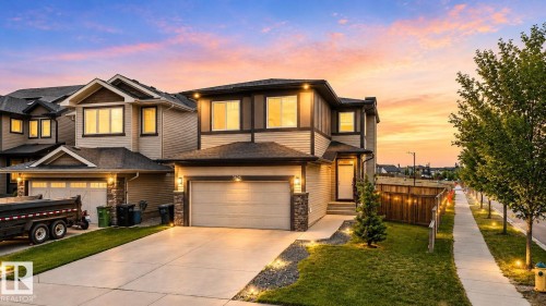 Two-story residence featuring light-colored siding with dark trim accents - 9628 221 Street, Edmonton, AB 