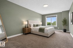 Spacious room featuring muted green walls and light brown carpeting - 