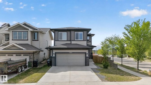 Two-story residence featuring a two-car garage with a concrete driveway - 9628 221 Street, Edmonton, AB 