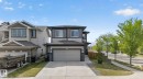 Two-story residence featuring a two-car garage with a concrete driveway - 9628 221 Street, Edmonton, AB 