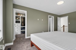 Bedroom featuring neutral wall paint, white trim, and gray carpet - 
