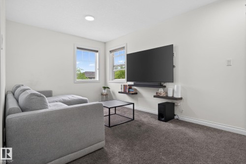 Carpeted interior space featuring white walls and recessed ceiling lighting - 9628 221 Street, Edmonton, AB 