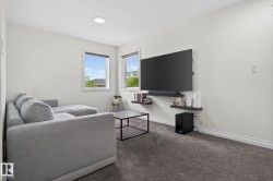 Carpeted interior space featuring white walls and recessed ceiling lighting - 