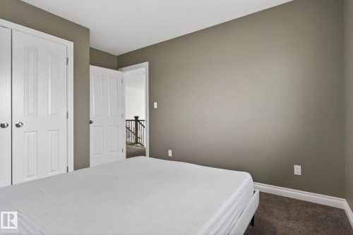 Bedroom featuring neutral wall paint, white trim, and a carpeted floor - 9628 221 Street, Edmonton, AB 