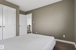 Bedroom featuring neutral wall paint, white trim, and a carpeted floor - 