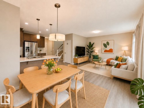 Open-concept living space featuring wood-finish flooring, recessed lighting, and neutral wall tones - 22519 96 Avenue, Edmonton, AB 