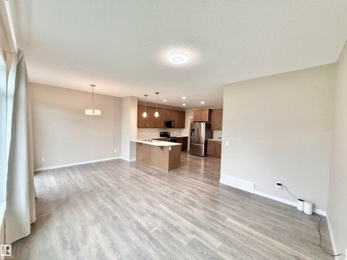 Spacious interior featuring wide plank wood-finish flooring and neutral wall tones - 22519 96 Avenue, Edmonton, AB 