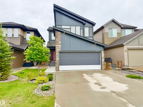 Contemporary multi-level exterior featuring dark gray siding and stone accents - 22519 96 Avenue, Edmonton, AB 